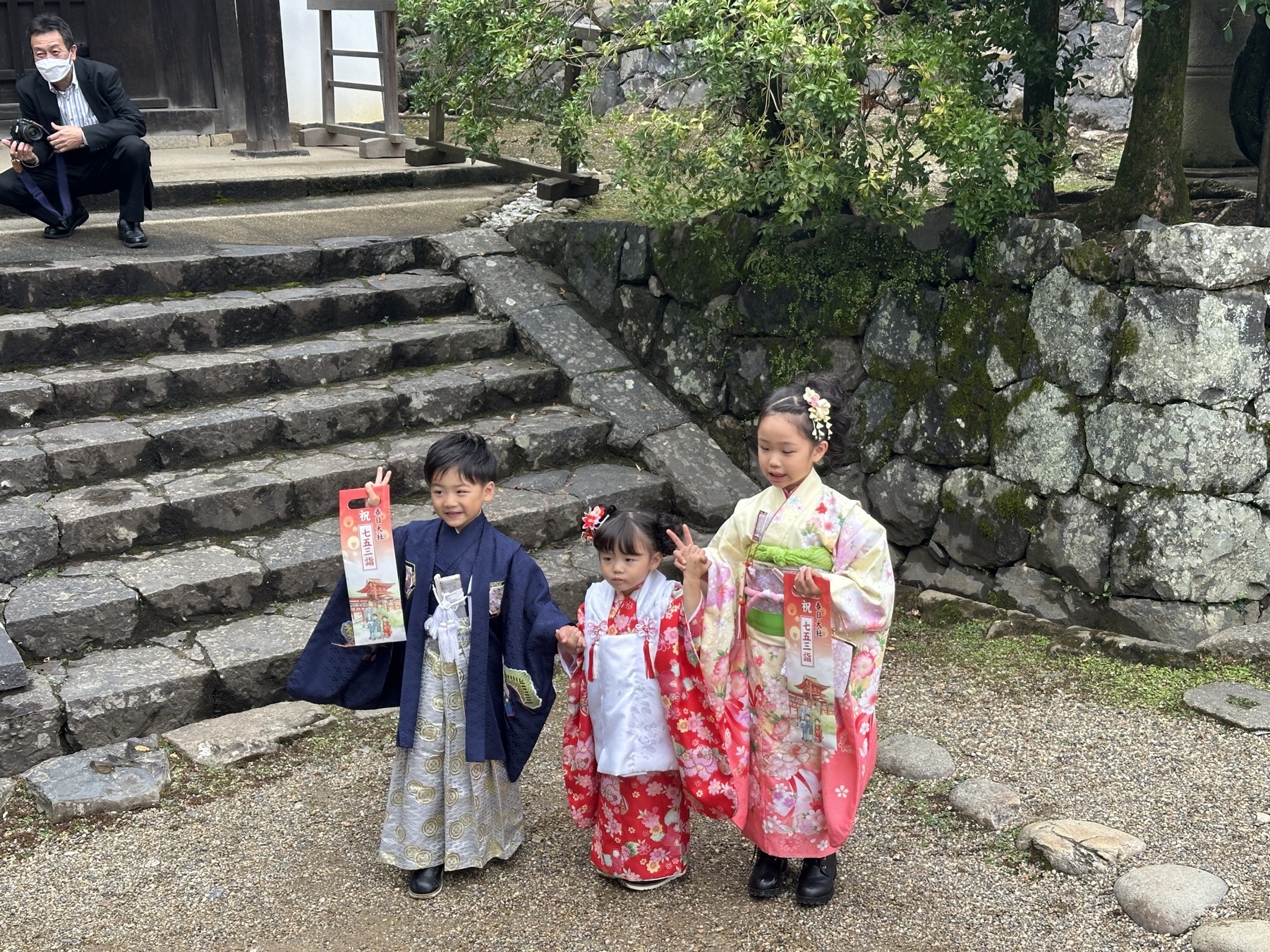 Children in kimono posing on stone steps